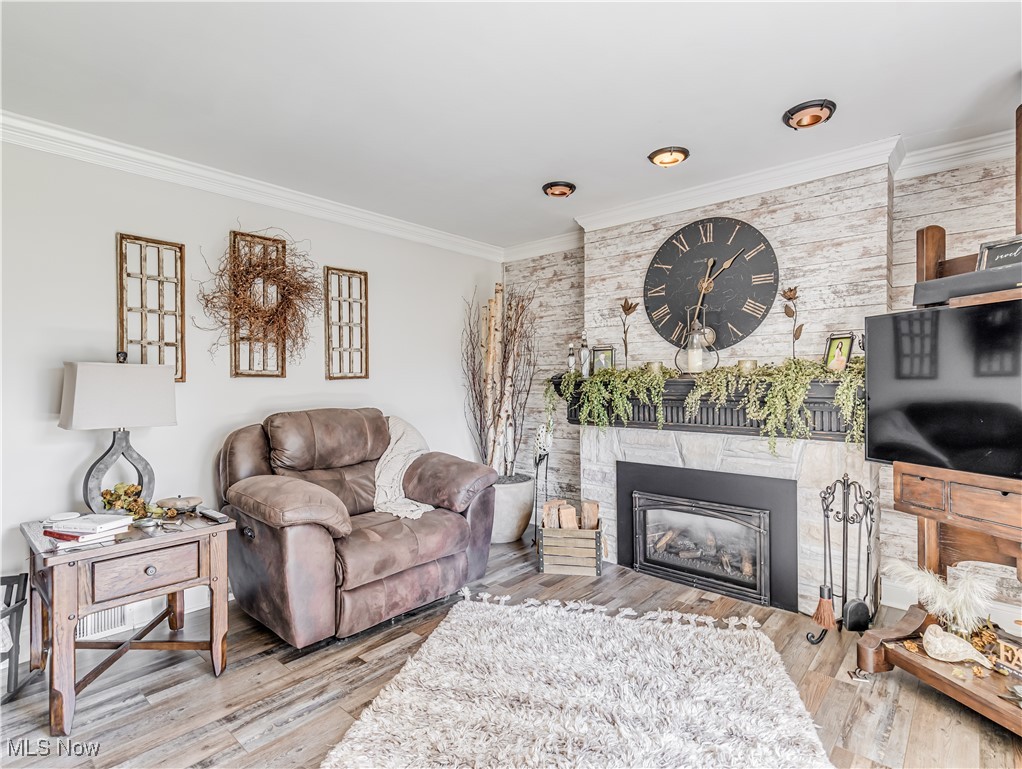 Living room featuring ornamental molding and hardwood / wood-style flooring