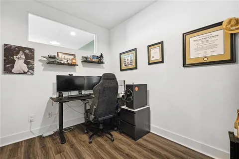 a view of a workspace with furniture and wooden floor
