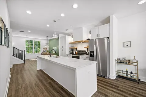 a kitchen with stainless steel appliances a refrigerator and a stove