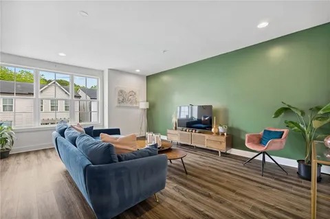 a living room with furniture and a flat screen tv