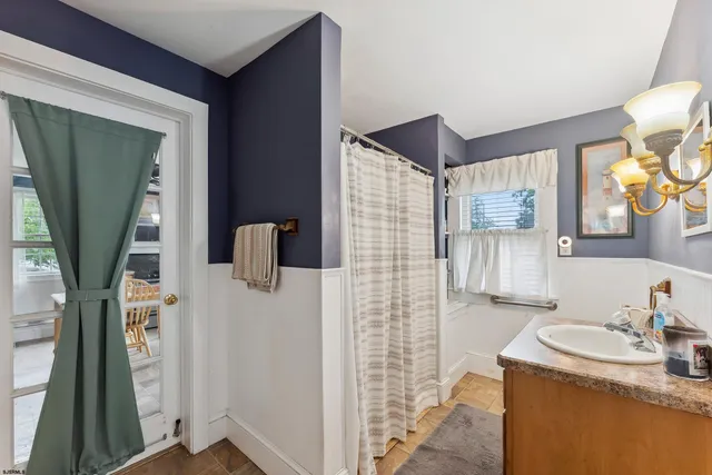 a bathroom with a sink a mirror and shower