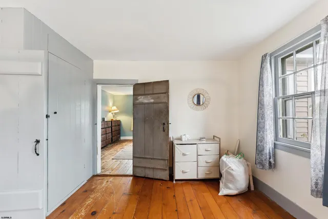 a bedroom with a bed and flat screen tv