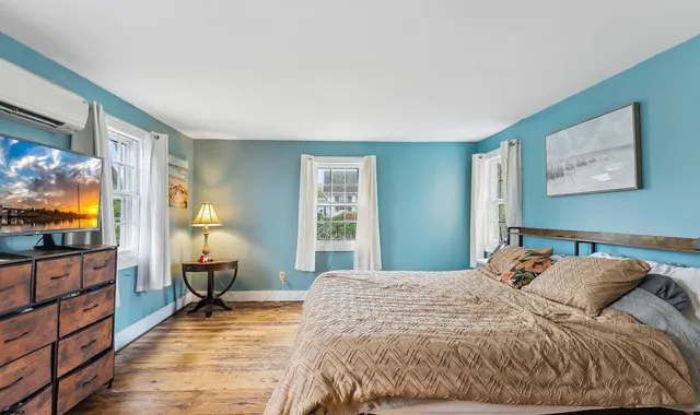 a bedroom with a bed and a dresser