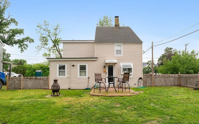 a backyard of a house with table and chairs