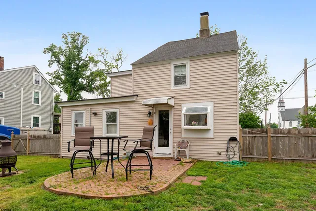 a view of a patio with table and chairs and potted plants