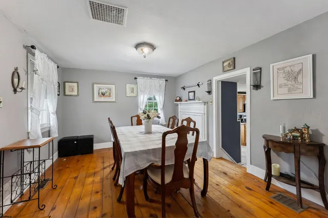 a dining room with furniture and window