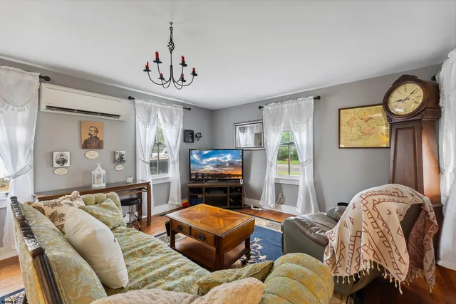 a living room with furniture a window and a clock