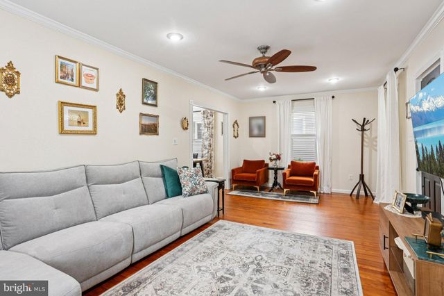 a living room with furniture ceiling fan and a rug