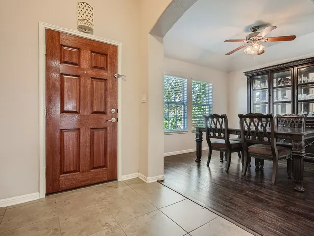 an empty room chandelier and windows