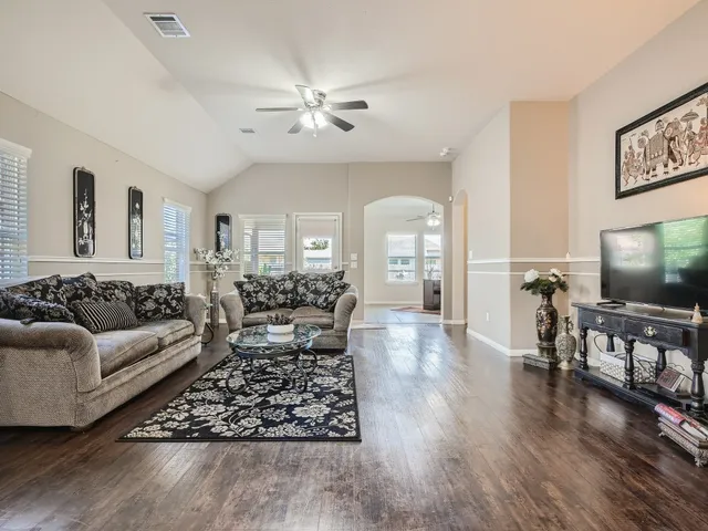 a living room with furniture and a flat screen tv