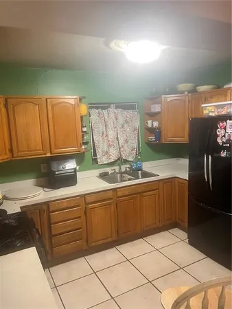 a kitchen with stainless steel appliances granite countertop a sink a stove and white cabinets