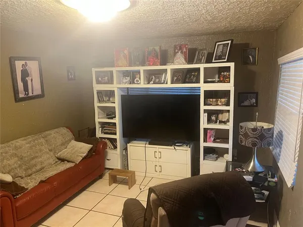 a bedroom with a bed and a wall painting