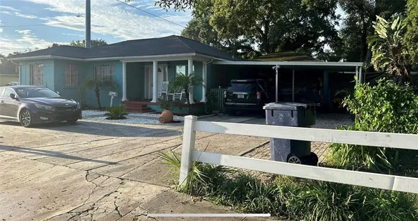 a view of an house with backyard space and garden