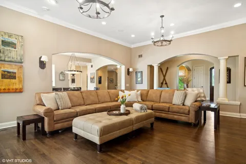 a living room with furniture kitchen view and a fireplace