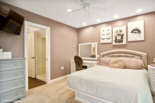 a kitchen with granite countertop white cabinets and white stainless steel appliances