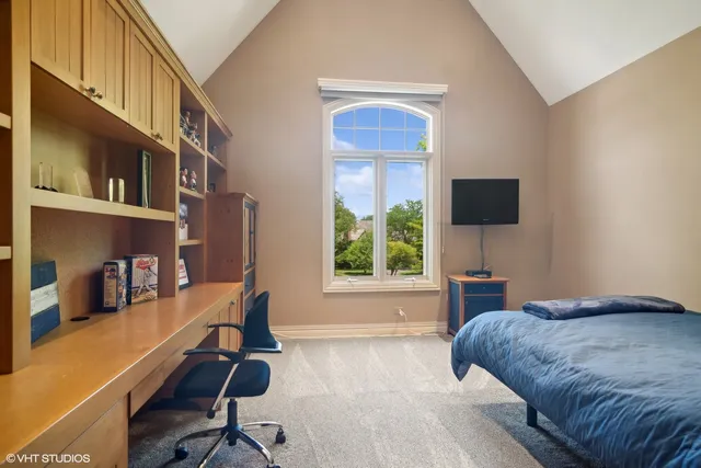 a living room with a bed furniture and a flat screen tv