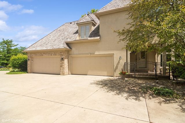 a view of a patio with couches table and chairs under an umbrella