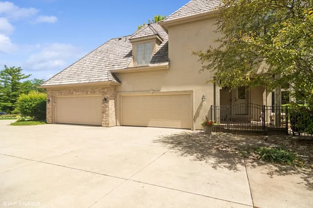 a view of a patio with couches table and chairs under an umbrella