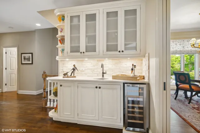 a kitchen with a sink cabinets and dining table chair