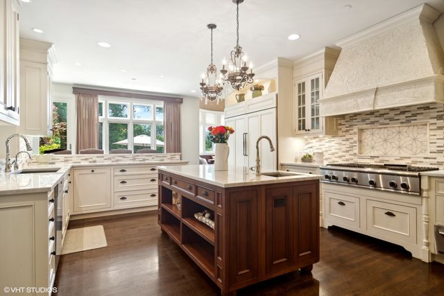 a kitchen with stainless steel appliances granite countertop a stove and cabinets