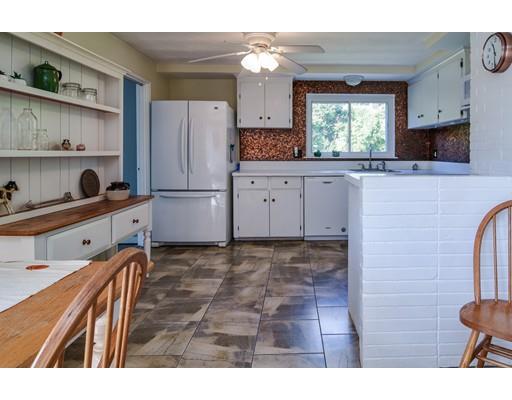23 Joseph Road Framingham, MA 01701 - Photo 5 of 20 a kitchen with kitchen island white cabinets and refrigerator