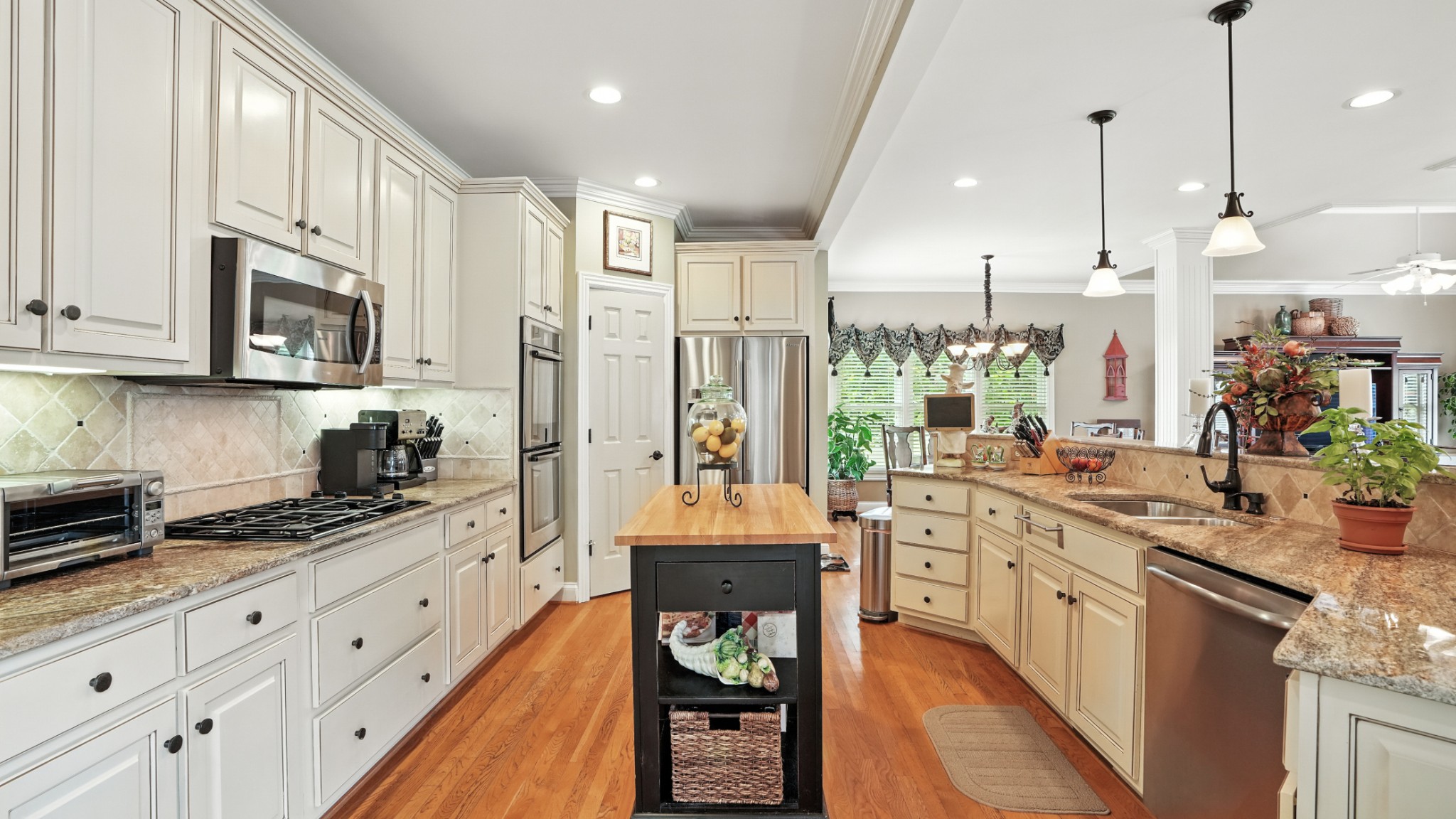 216 Lake Ridge Court Franklin, TN 37069 - Photo 27 of 75 a large kitchen with stainless steel appliances granite countertop a stove a sink dishwasher and a refrigerator with wooden floor