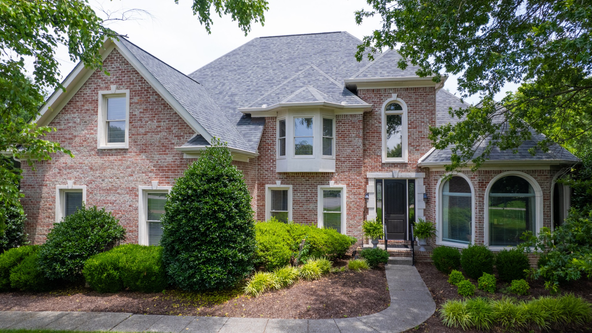 216 Lake Ridge Court Franklin, TN 37069 - Photo 3 of 75 a front view of a house with garden