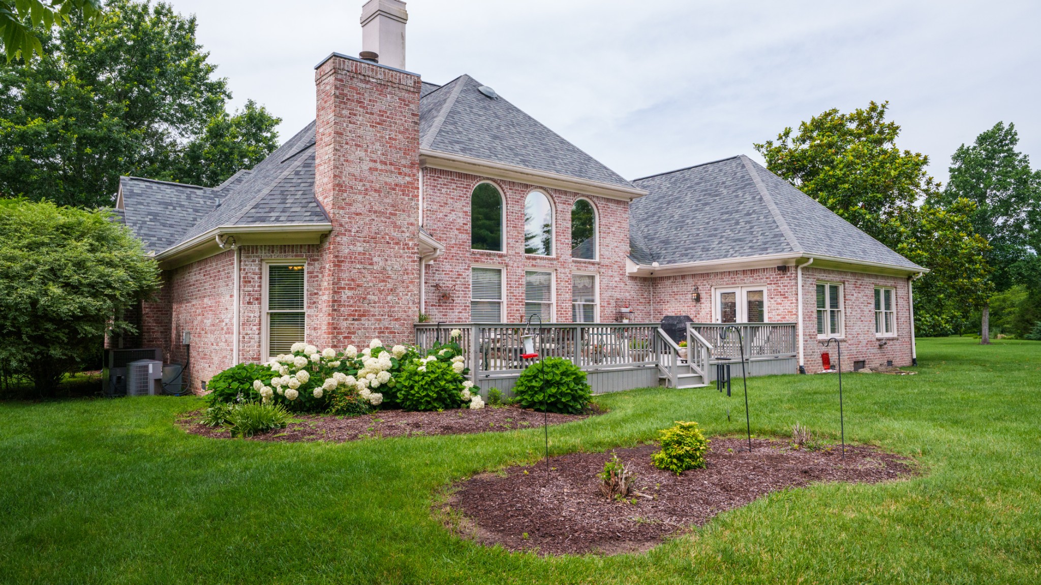 216 Lake Ridge Court Franklin, TN 37069 - Photo 67 of 75 a front view of a house with a garden and plants
