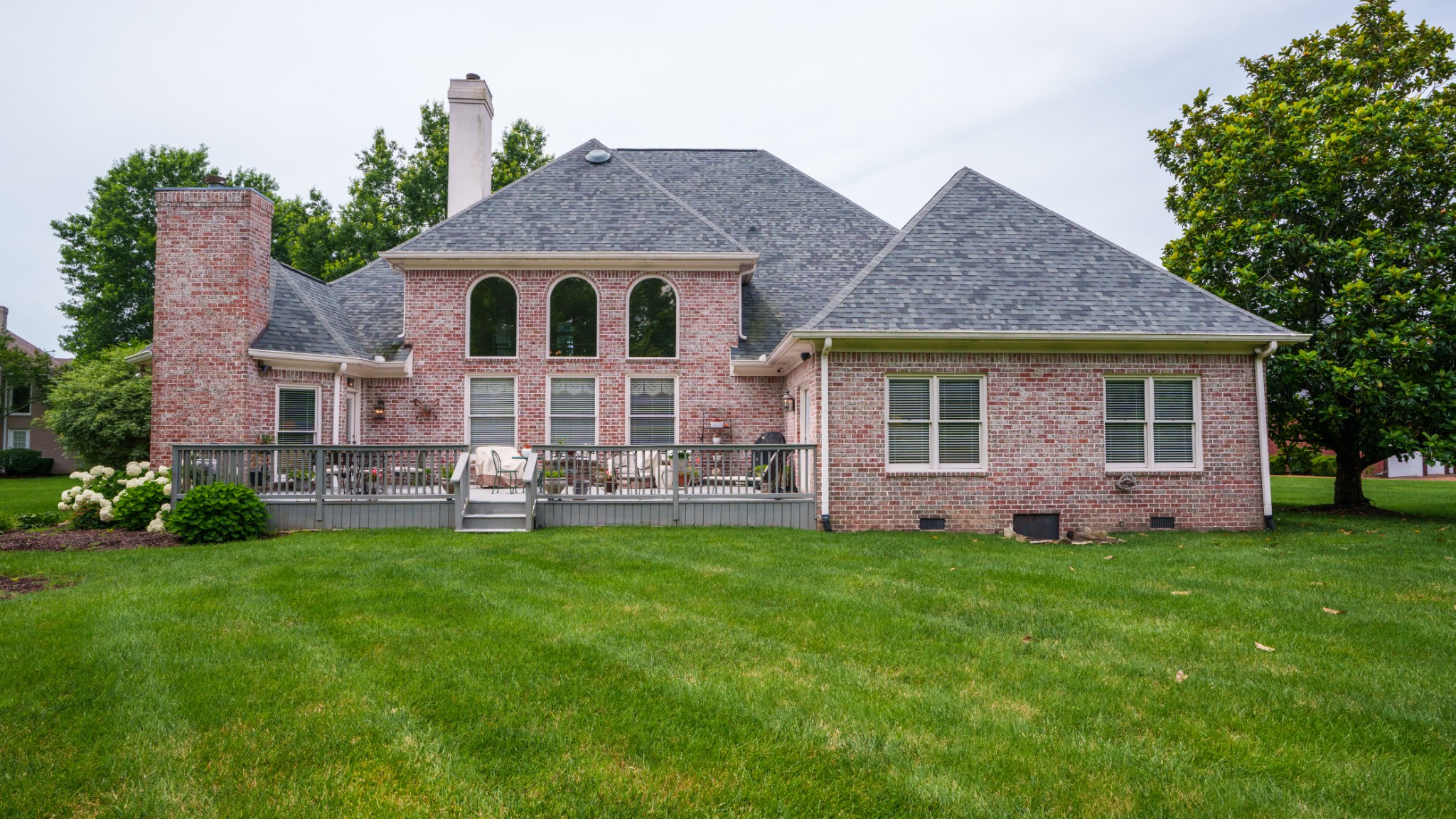 216 Lake Ridge Court Franklin, TN 37069 - Photo 69 of 75 a front view of a house with a garden and trees