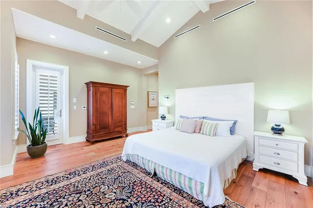 a bedroom with a bed and a potted plant