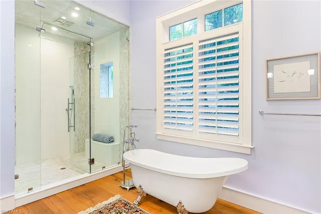 a bathroom with a bathtub and a shower