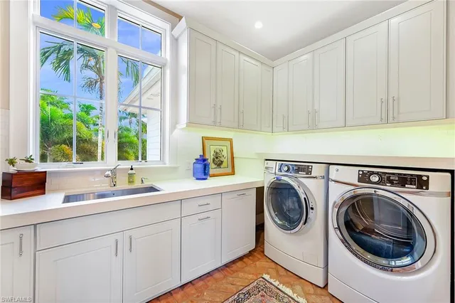 a utility room with sink dryer and washer