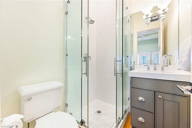 a bathroom with a toilet a sink and shower