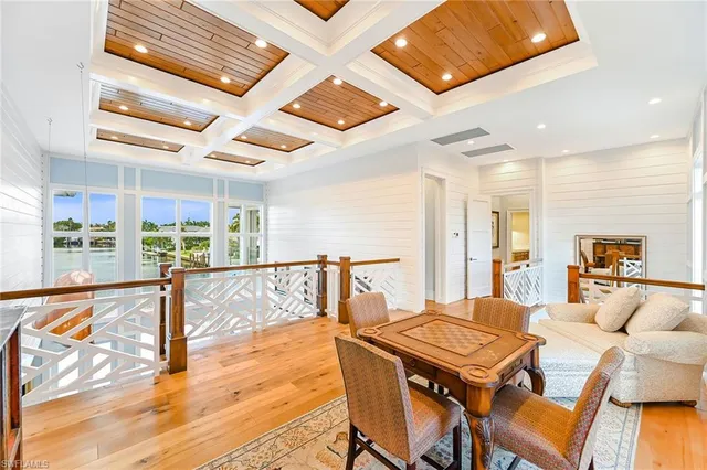 a dining room with furniture and a floor to ceiling window