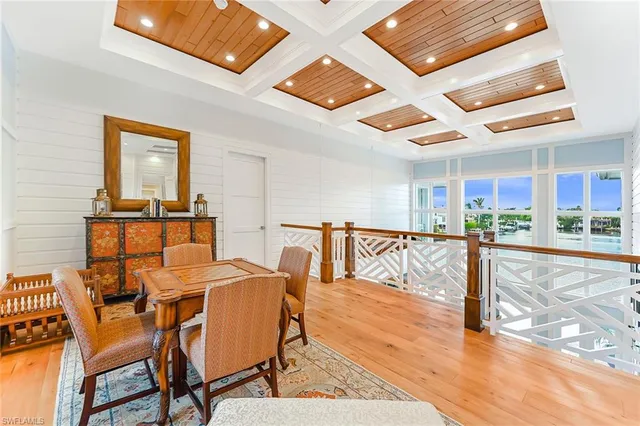 a bedroom with a bed couch and a large window