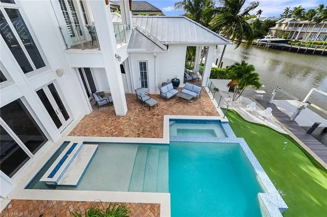 a view of a lake with couches chairs