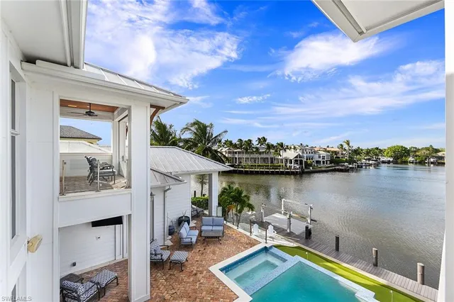 swimming pool with outdoor seating and outdoor shower