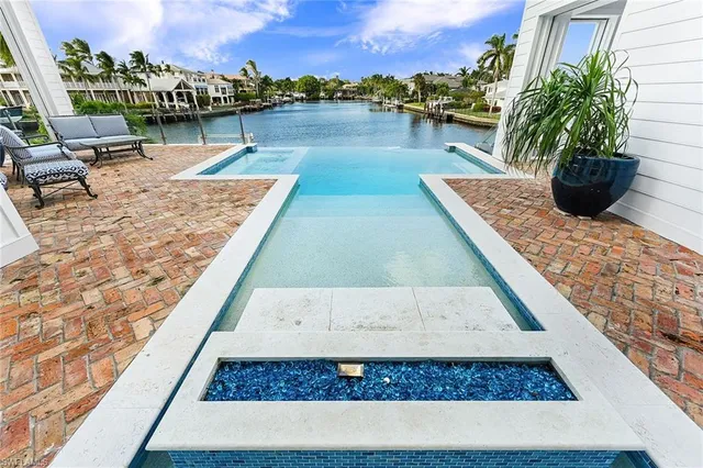a view of a swimming pool with an outdoor seating