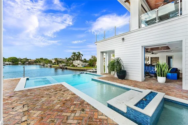a view of a lake with couches chairs
