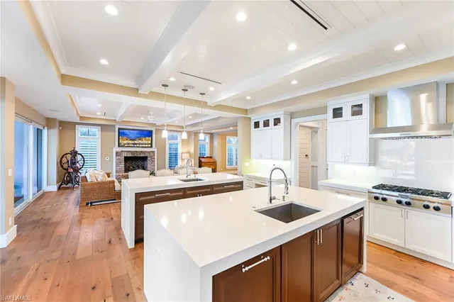 a kitchen with kitchen island a sink stove and wooden floor