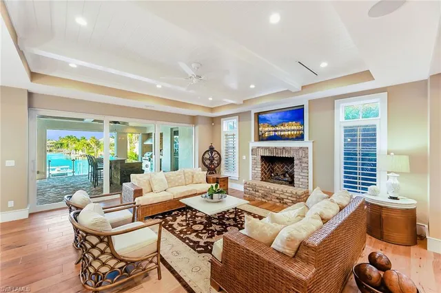 a living room with furniture fireplace and a large window