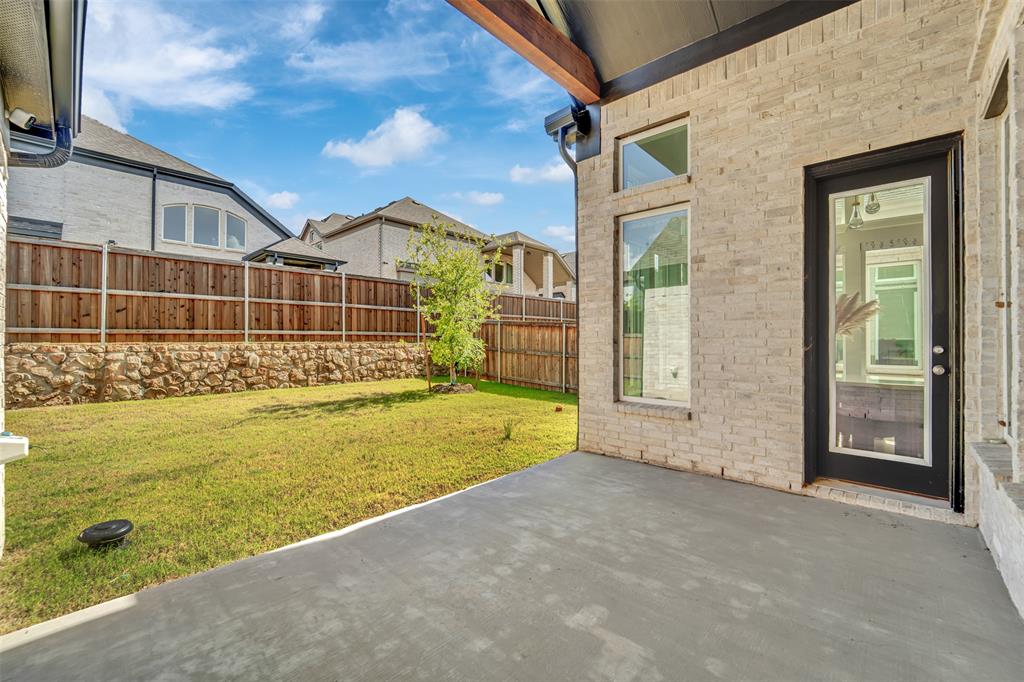 3520 Helios Lane Corinth, TX 76208 - Photo 35 of 37 Covered patio featuring a concrete slab and a light brick exterior
