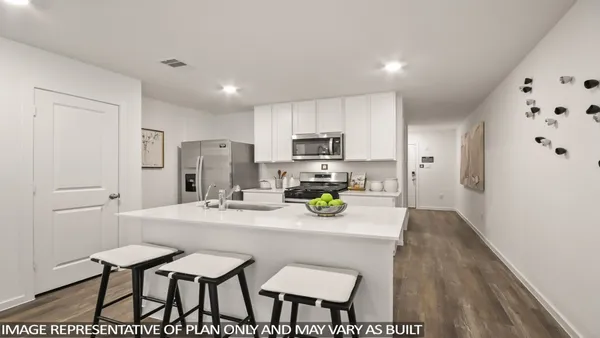 a kitchen with a dining table chairs and refrigerator