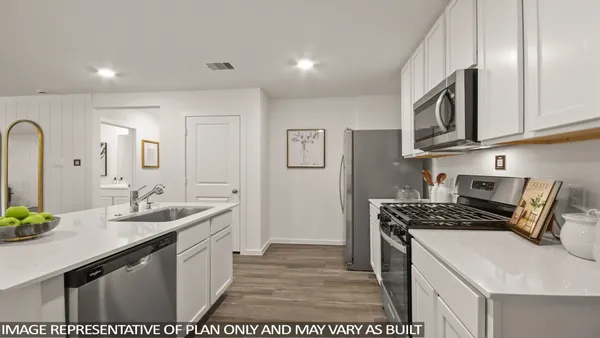 a kitchen with stainless steel appliances granite countertop a sink stove and cabinets