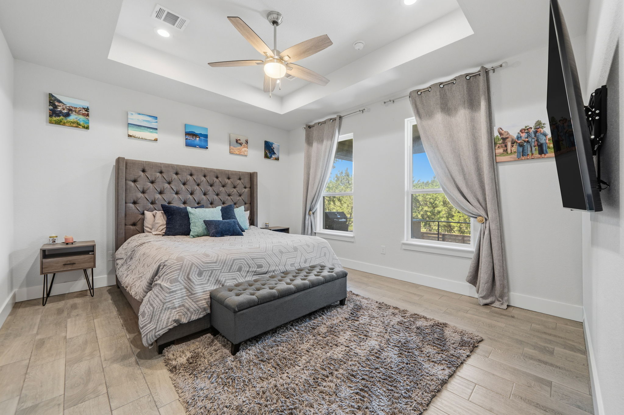 18605 Masters Cove Point Venture, TX 78645 - Photo 16 of 40 Recessed lighting illuminating a spacious room with a tray ceiling and a ceiling fan