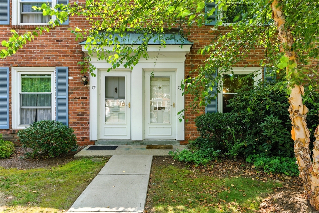 73 Yorktown Drive, Unit 73 Springfield, MA 01108 - Photo 1 of 42 a front view of a house with garden