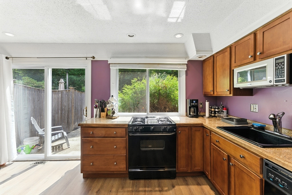 73 Yorktown Drive, Unit 73 Springfield, MA 01108 - Photo 11 of 42 a kitchen with stainless steel appliances granite countertop a stove a sink and a microwave