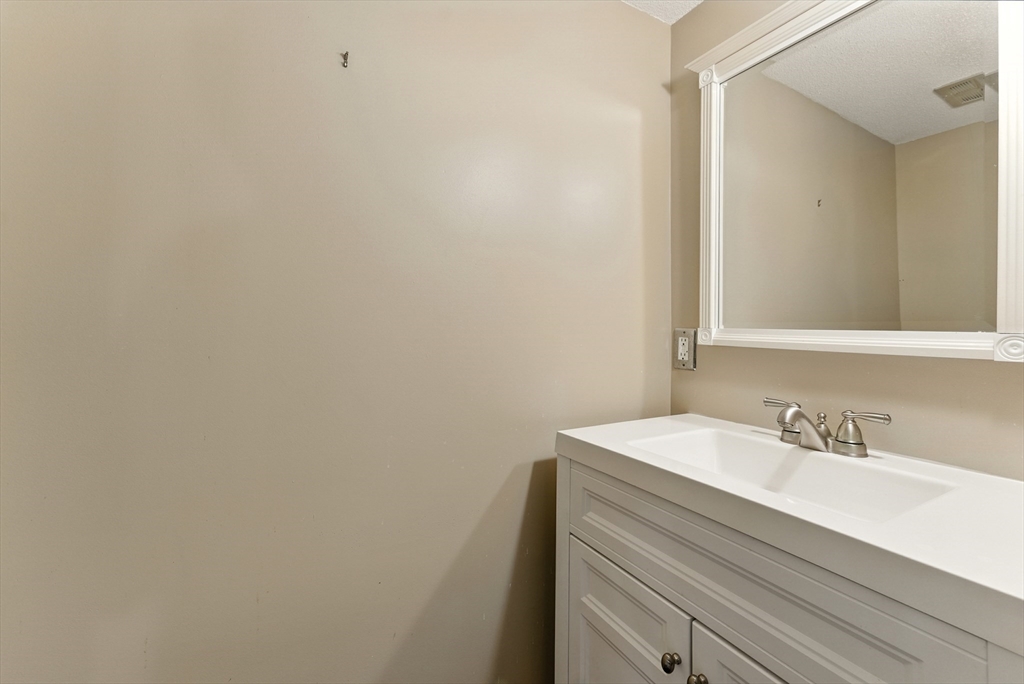 73 Yorktown Drive, Unit 73 Springfield, MA 01108 - Photo 13 of 42 a bathroom with a sink and a mirror