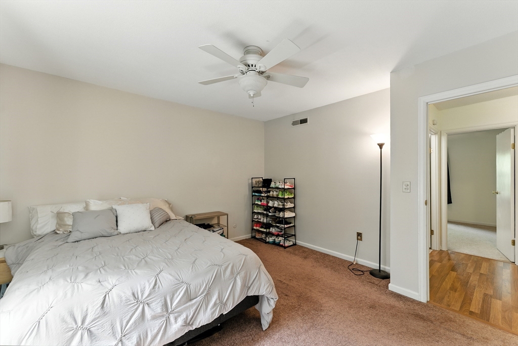 73 Yorktown Drive, Unit 73 Springfield, MA 01108 - Photo 16 of 42 a bedroom with a bed and a chandelier