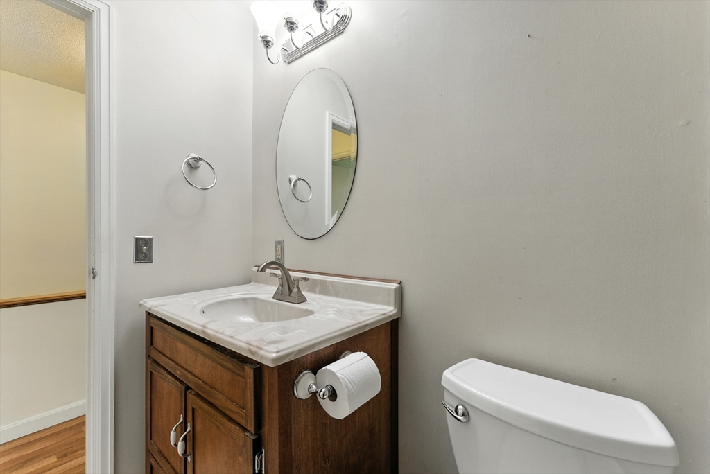 73 Yorktown Drive, Unit 73 Springfield, MA 01108 - Photo 19 of 42 a bathroom with a toilet sink and mirror